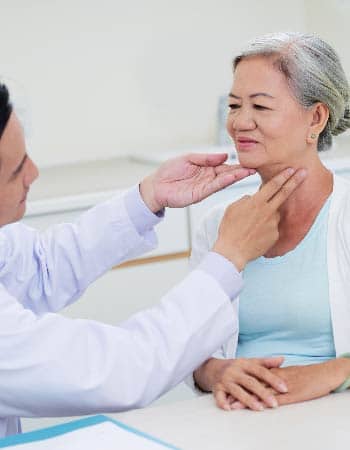 A doctor conducting physical exam for a mature patient.